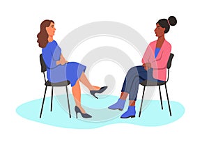 Two women sit opposite each other on chairs