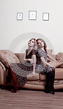 Two women back to back photo