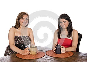 Two women sitting having coffee at table