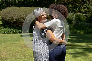 Two women smiling to camera in the garden