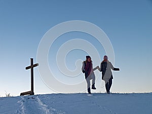 Two women snow fun at hill in country by blue hour. Happiness