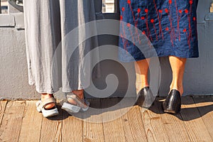 Two Women Standing on Tiptoes. Curiosity Concept