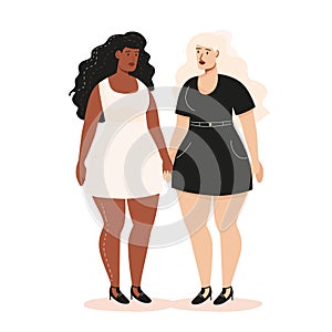 Two women standing together, one Black white dress, Caucasian black dress, both confident looks photo