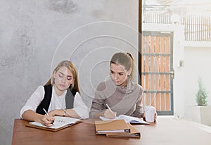 Two women are studying and teaching