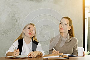 Two women are studying and teaching