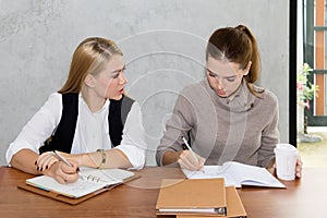 Two women are studying and teaching