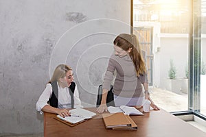 Two women are studying and teaching