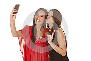 Two women take picture of selves peace
