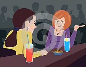 Two women talking at bar counter