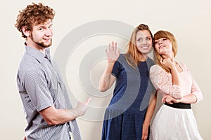 Two women talking gossiping about man.