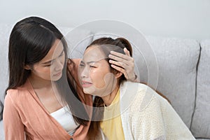Two women talking about problems at home. Asian women embrace to calm their sad best friends from feeling down. Female friends