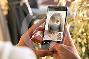 Two women talking to each other through a video call on a smartphone. Senior woman having a video chat with a girl on mobile phone