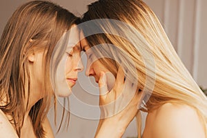 Two women touch each other& x27;s foreheads. Women& x27;s health, relaxation, rest, mental health harmony