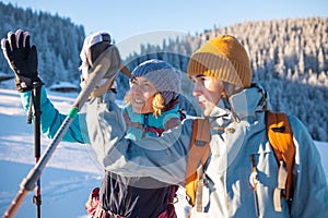 Two women walk in the winter trekking