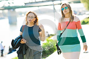 Two women walking along the waterfront