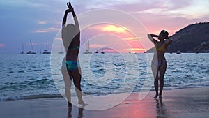 Two women walking back to the beach in the beautiful sunset.