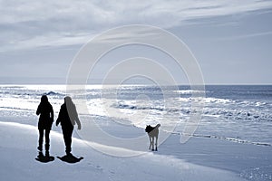 Two women walking at the beach