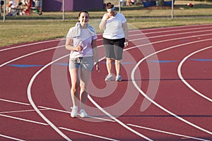 Two women walking a track