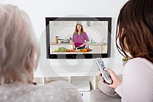 Two Women Watching Cooking Show On Television photo