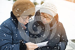 Two women watching pictures. photo