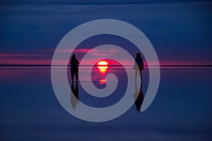 Two women watching the sunset at the salt Lake Elton