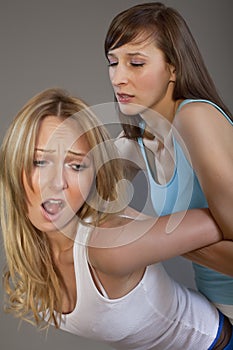 Two women wrestle