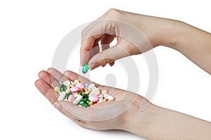 Two womens hands hold color pharmaceutical pills