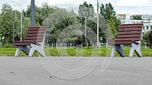 Two wooden benches in a public Park