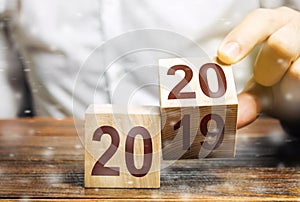 Two wooden blocks with numbers 2019 and 2020. Concept beginning of new year. New objectives. in next decade. Trends in the world. photo