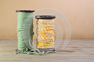 Two Wooden Bobbins with Yarn