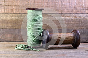 Two Wooden Bobbins with Yarn