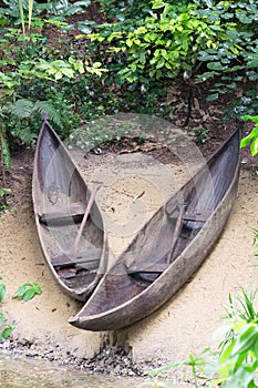 Two wooden canoes on the shore