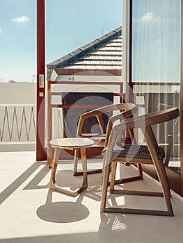 Two wooden chairs and a coffee table on the terrace