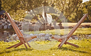 Two wooden chaise lounge in a park. Amsterdam