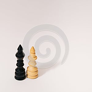 Two wooden chess figures. King and the queen on a white background. Minimal concept. Copy space