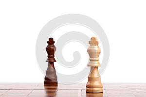 Two wooden chess pieces, black and white king on the board. Strategy, isolated on white background