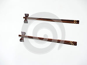 Two wooden chopsticks on bar.