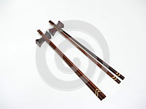 Two wooden chopsticks on bar.