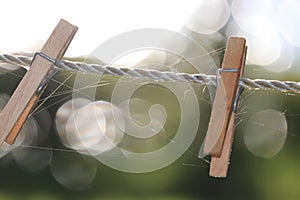 Two wooden clothespins clothes pegs on clothesline