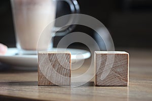 Two wooden cubes with cacao cup. Selective focus. Choise concept