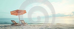 Two wooden deck chairs and one parasol on sandy empty beach on seashore