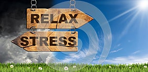 Two Wooden Directional Signs with Text Relax and Stress