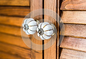 two wooden door handles close up