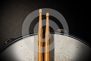 Two wooden drumsticks on an old snare drum - Percussion instrument