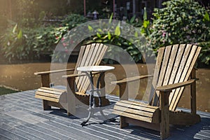 Two wooden easy chairs  on the wood floor in park