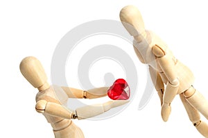 Two wooden figures of a dummy, give a red heart, isolated on a white background - pictures of the theme concepts Love