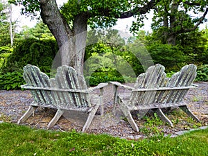 Two Wooden Grungy Outdoor Loveseats photo