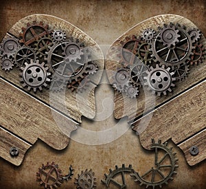 Two wooden heads with gears coming into collision concept photo