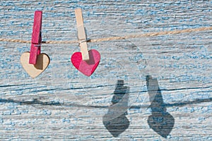 Two wooden hearts on the background of the old blue  textural wooden wall.