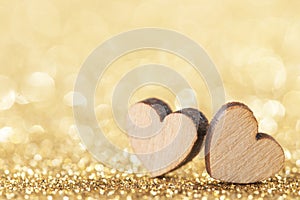 Two wooden hearts and golden lights